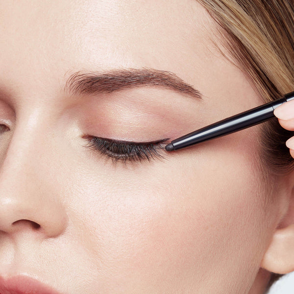 Starting at the outer corner of the eye, tracing just above the lash line to the inner corner of the eye. 
