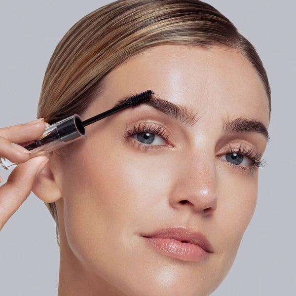 Using the comb side of Hi-Def Brow Gel's unique styling tool, shape and align brow hairs with short, upward strokes following the natural arch of your eyebrows. Twist and pull tinted brow gel applicator brush from base. Using short, upward strokes, apply tinted gel to eyebrows, moving from the inner to outer corners to sculpt and define.   