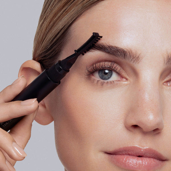 Twist and pull brow gel applicator brush from base. Using short, upward strokes, apply gel to eyebrows, moving from the inner to outer corners to sculpt and define.
 