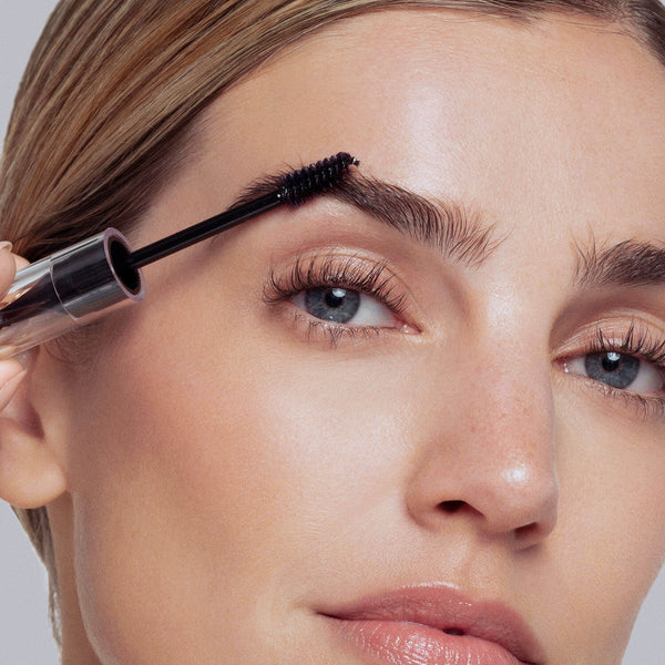 Using the comb side of the unique styling tool, shape and align brow hairs with short, upward strokes following the natural arch of your eyebrows. 